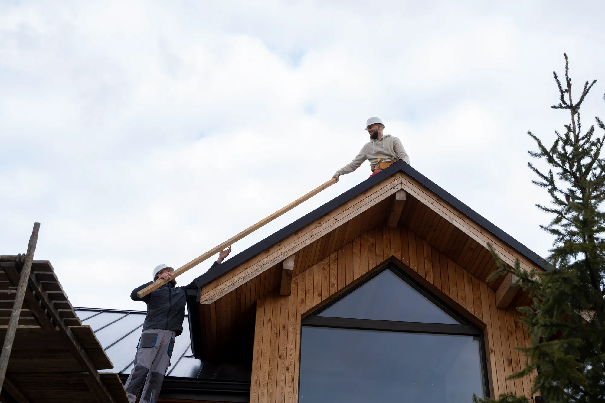 Builder installing a timber-clad rear dormer loft conversion